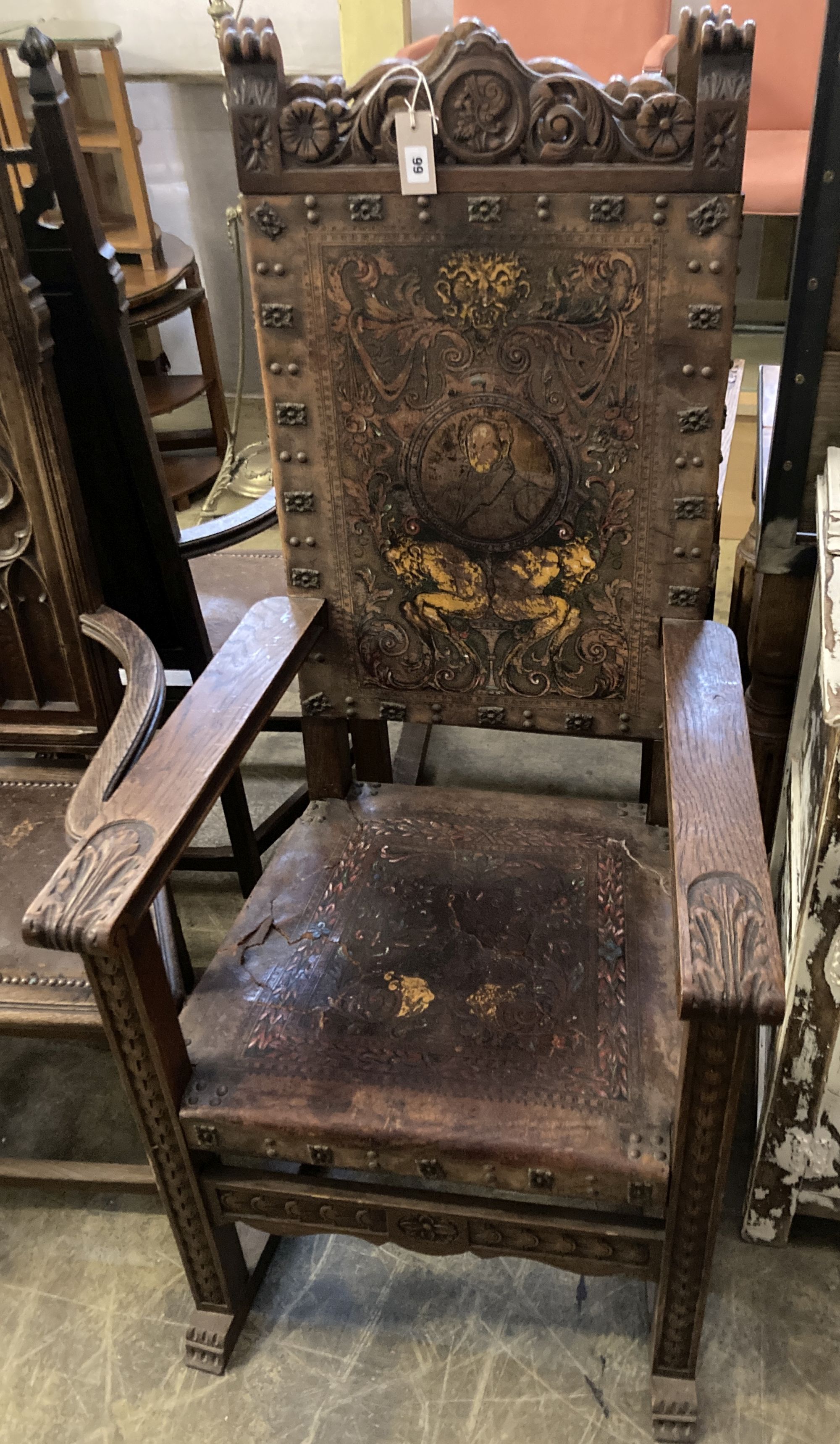 A pair of Spanish oak elbow chairs, width 62cm, depth 52cm, height 128cm